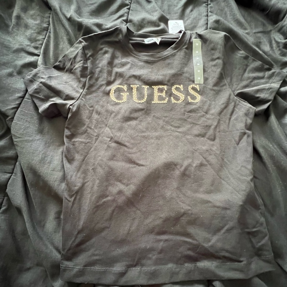 Guess Charcoal Black Tee with Gold Logo Women’s BRAND NEW WITH TAGS SHOWN